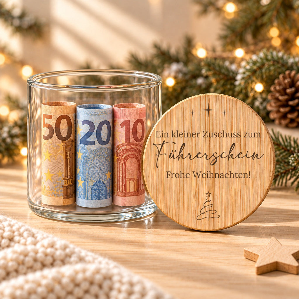 Geldgeschenk Weihnachten im Glas: offenes Glas mit gerollten Geldscheinen, daneben lehnt der gravierte Bambusdeckel „Zuschuss zum Führerschein“