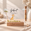 Geldgeschenk zur Geburt als Acryl-Aufsteller im Giraffen-Design: Giraffenbaby mit Gänseblümchen, Röhrchen mit Geldschein