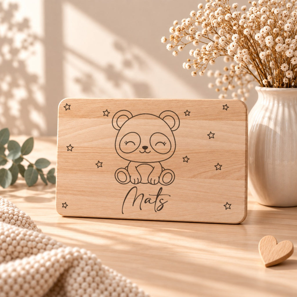 Frühstücksbrettchen aus Holz mit einem Panda, aufgestellt neben Schleierkraut