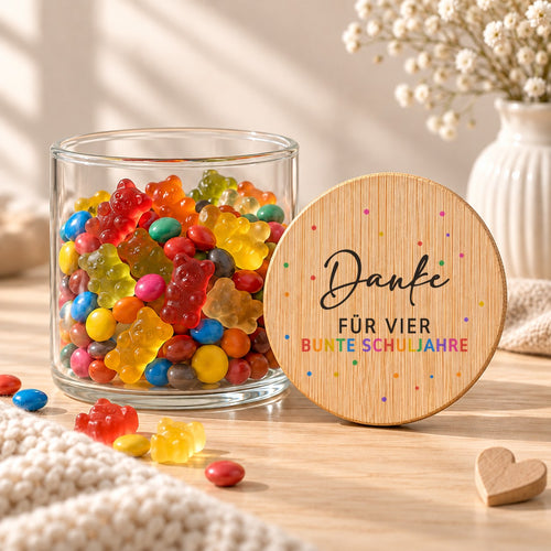 Offenes Vorratsglas mit Gummibärchen, daneben lehnt der Deckel „Danke für vier bunte Schuljahre“