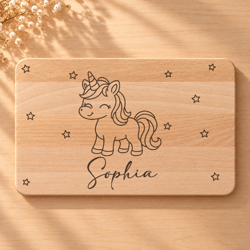 Nahaufnahme der Lasergravur: Einhorn und der Name Sophia in Schreibschrift auf hellem Holz