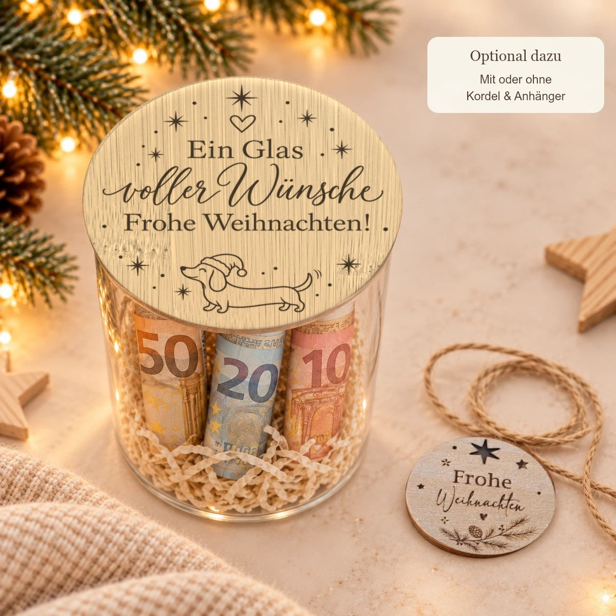 Glas „Ein Glas voller Wünsche“ mit Holzwolle, daneben Kordel und Holzanhänger „Frohe Weihnachten“, optional für 1 € mehr
