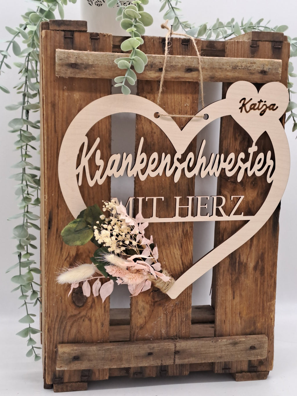 Nahaufnahme vom Holzherz „Krankenschwester mit Herz“ mit Name Katja und Trockenblumen